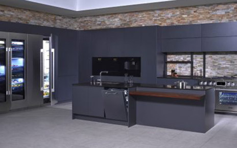 A kitchen consisting of SIGNATURE KITCHEN SUITE collection in black backdrop with brick walls