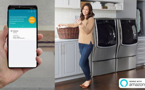 A woman holds a laundry basket while looking at her phone in front of LG laundry appliances, with a close-up of the smartphone displaying the remaining wash time and an option to set up Amazon Dash Replenishment.