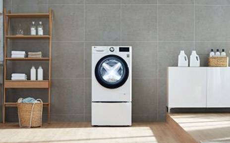 LG washing machine with AI DD™ in a laundry room