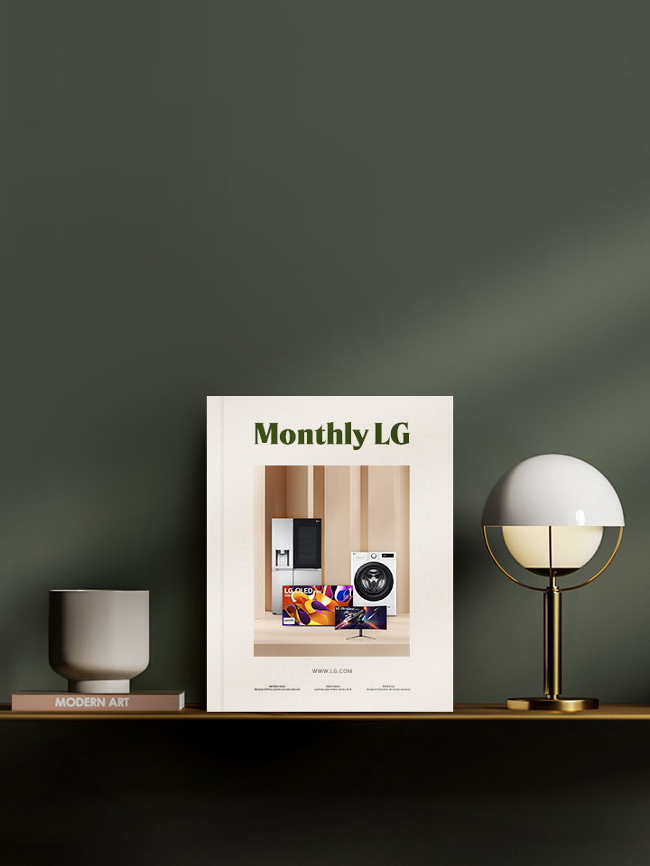 monthly lg book cover standing on a smart sideboard over a dark green wall